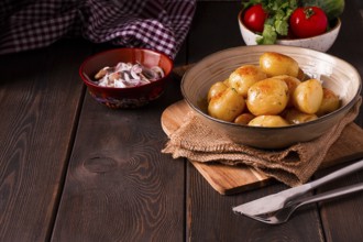 Fresh Cooked, new potatoes, with dill, on a wooden table, selective focus. close-up, toning, no