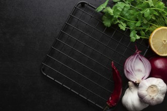 Food concept, black table, hot plate, spices, top view, no people horizontal