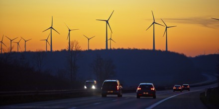 Wind turbines at sunrise with cars on the A 44 motorway, Büren, Paderborn plateau, North