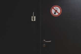 A sign banning mobile phones is stuck to a door in the German Bundestag in Berlin, 11.03.2024