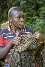 Pygmy woman of the Baka or BaAka people with her hunting net, Dzanga-Sangha Special Dense Forest