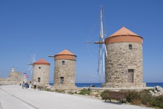 Windmills on the pier at Mandráki harbour, Rhodes Town, Rhodes, Dodecanese, Greece, Europe