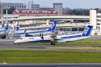 An ANA Wings Dash 8 Q400 aircraft with registration number JA842A at Itami Airport (ITM) in Osaka,