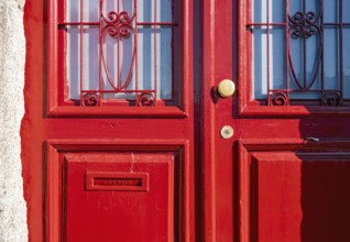 Close-up of vividly red doors on the historical façade in the Ribeira district, Porto, Portugal,