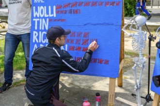 Richard Cluse marks the 60th day of his hunger strike on a large board. On the right, a skeleton