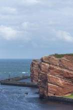 Red coloured sandstone, steep cliff coast of the offshore island of Heligoland, home of the