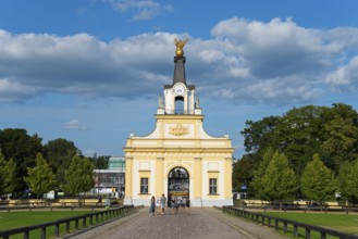 Classical entrance gate with sculpture and people under a blue sky, Gatehouse, Branicki Palace,