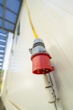 Close-up of a red socket on the outside wall of a container building, Beermiß refugee accommodation