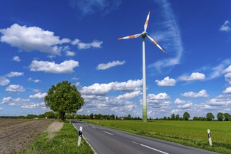 Wind turbine, wind energy plant from the manufacturer Enercon, blue sky with many white clouds,