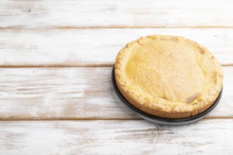 Autumn onion pie and cup of coffee on white wooden background. Side view, copy space, close up