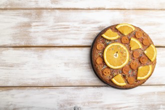 Orange cake on a white wooden background. Top view, flat lay, copy space