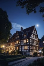 Traditional half timbered house nestled within the heart of a picturesque village at night, AI