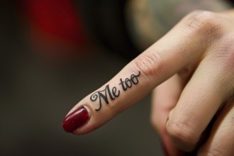 Close up of tattoo with text 'Me too' on woman's finger. Generative AI, AI generated