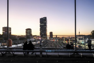 Chilling out at sunset on the Modersohn Bridge, view of railway tracks, trains and the 140 metre