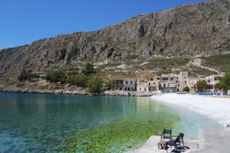 Secluded bay with crystal clear water and houses under steep mountains, Geromilenas, Mani, Laconia,