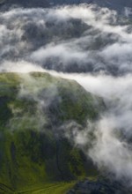 Fog, clouds moving around moss-covered mountains, impressive landscape, Pakgil, Iceland, Europe