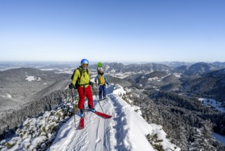 Two ski tourers on a mountain ridge, on the ascent to the Teufelsstättkopf, snowy mountain