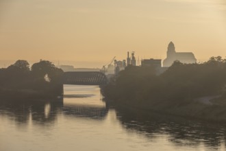 Elbe with harbour bridge, harbour area and mill in atmospheric morning light, Dresden, Saxony,