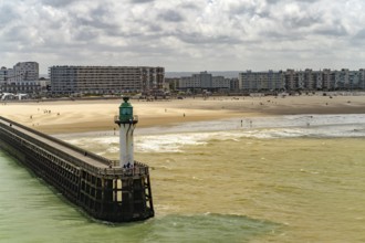 Lighthouse of the harbour entrance and beach of in Calais, France, Europe