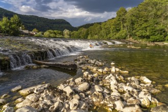 Children bathing at the weir in the Doubs river near Ocourt, Switzerland, Europe