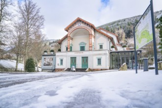 Wide angle shot of a historic theatre in the snow, surrounded by wintry nature, Königliches