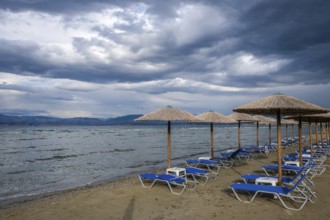 Kalamaki, Corfu, Greece, Sun loungers and parasols on Kalamaki beach in the north-east of the Greek