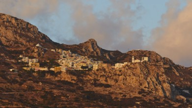 Small village on a rocky mountain side in soft morning light, Mountain village Menetes, Morning