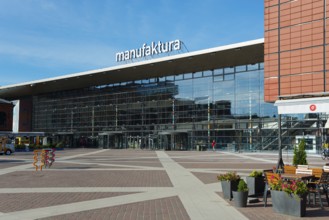 Large modern glass façade of the Manufaktura shopping centre on a sunny day, Manufaktura, Lódz,