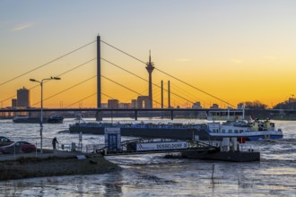 Sunset on the Rhine near Düsseldorf, skyline of the city centre with Rhine Tower, Rheinkniebrücke,