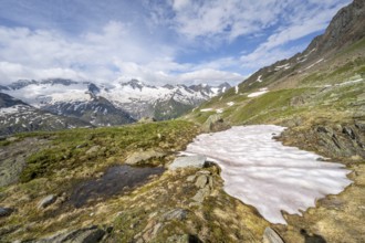 Picturesque mountain landscape with snowfield, mountain peaks with snow and glacier