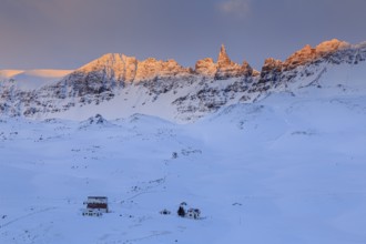 Lonely farm in front of pointed mountains in the morning light, winter, snow, Akureyri, North