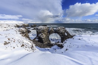 Rock gate at the coast, cliffs, snowstorm, sun, snow, winter, Arnarstapi, Snaefellsnes, Vesturland,