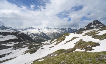 Picturesque mountain landscape with snow remains, mountain peaks with snow and glacier