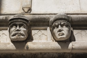 Sculpted faces and carved architectural details on outside wall of The Cathedral of Saint James,