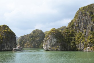 Excursion boats and the karst rocks in Lan Ha Bay, Halong Bay, Vietnam, Asia