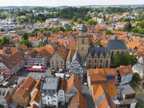 Aerial view of a historic town with half-timbered houses and a large church in the centre, aerial