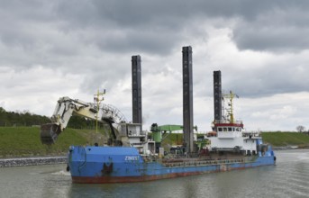 Working with a dredger on the Kiel Canal to widen the canal, Kiel Canal, Schleswig-Holstein,