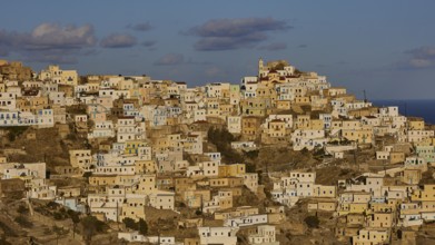 A village built on terraces, revealing most of its structures in the morning, Colourful mountain