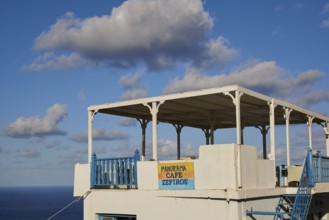 Coffee veranda with sea view and blue sky, equipped with blue railings, Colourful mountain village,