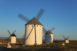 Four windmills in a sunny landscape panorama, Campo de Criptana, province of Ciudad Real,