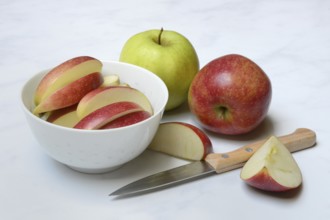 Apple and apple slices in peel, sliced apple with knife