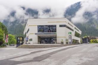 Modern building with large window front in foggy weather in the Alps, Mayrhofen, Zillertal,