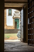 Facade of a baroque church seen from inside a historic prison from the time of the empire in the