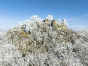 Aerial view of the snow-covered Hegau volcano Mägdeberg, with remains of a castle wall, surrounded