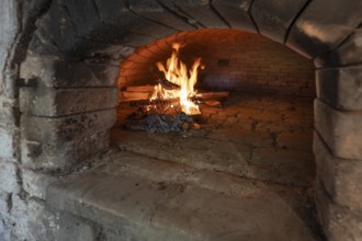 Wood fire in a baking oven in preparation for baking bread, baking oven festival in Franconia