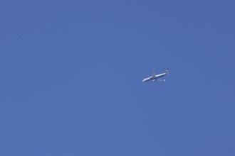 Boeing 737 jet aircraft of Ryanair airlines in flight across a blue sky, England, United Kingdom,