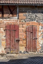 Historic farmhouse around 1800, half-timbered façade, sandstone, natural stone, brick, weathered