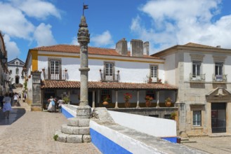 Idyllic street scene with old buildings, café and relaxed passers-by, Pelourinho de Óbidos,