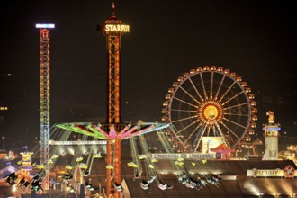 View over the Wies'n at night with illuminated carousel, Ferris wheel, stalls, beer tents and