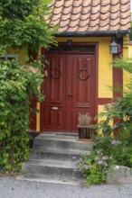 Door in typical half-timbered yellow house in Gudhjem, Bornholm, Baltic Sea, Denmark, Scandinavia,